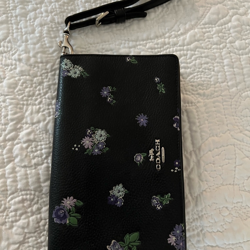 Coach black wallet with wrist strap.